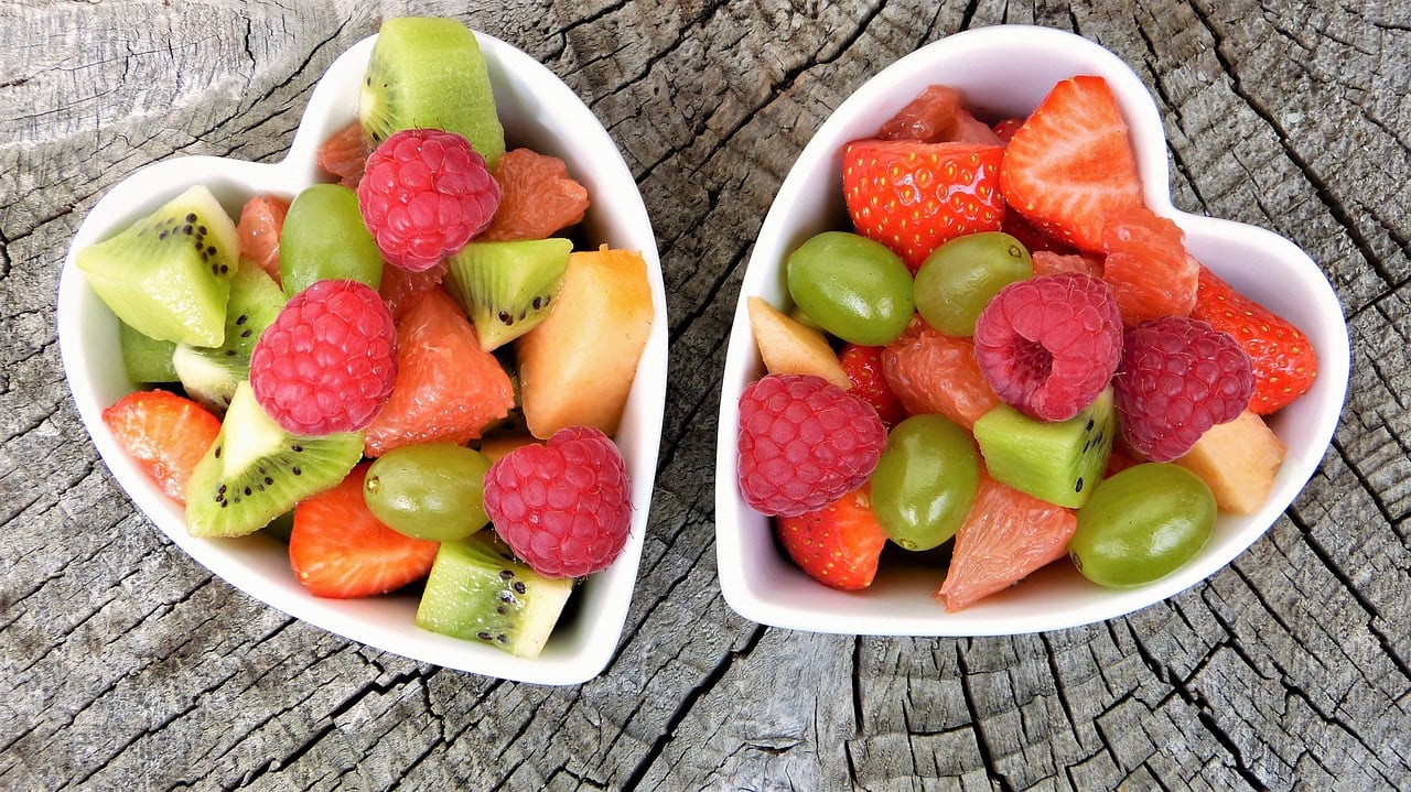 two white heart bowls filled with fruit salad typical of the menopause diet 5 Day Plan