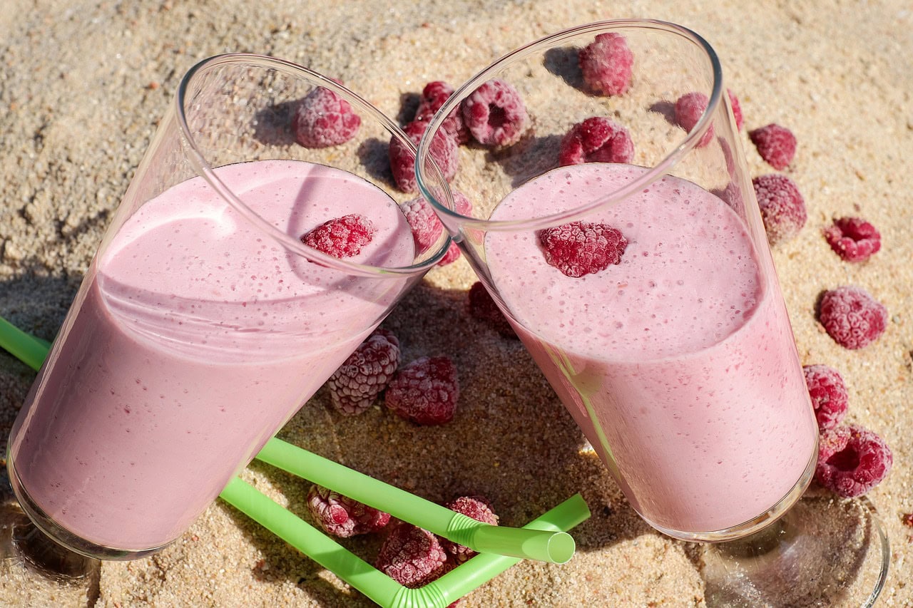 pink smoothies on a beach protein shake recipes to lose weight