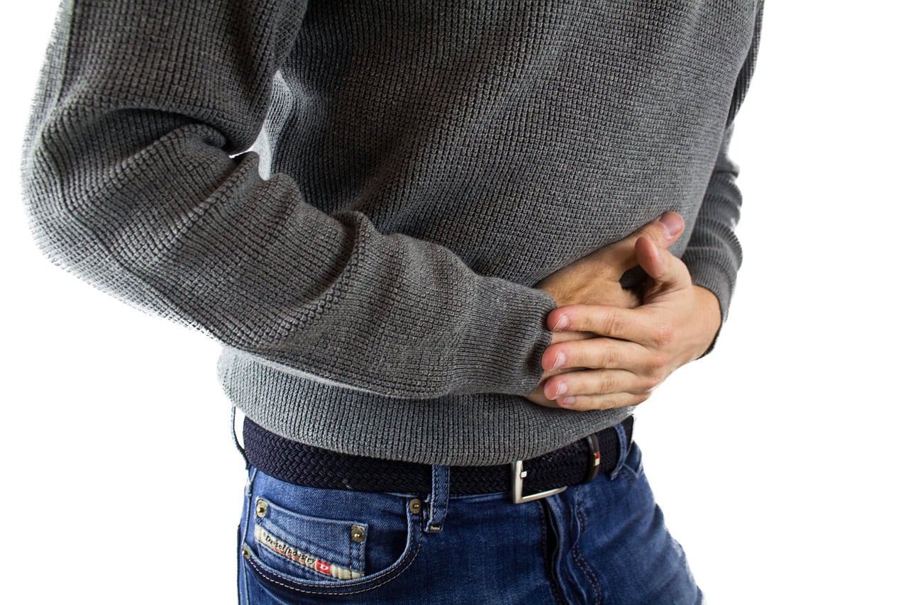 Person holding stomach possible bloating from Mounjaro constipation