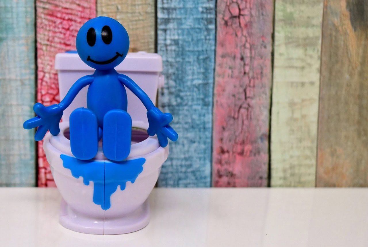 Blue figure on toilet