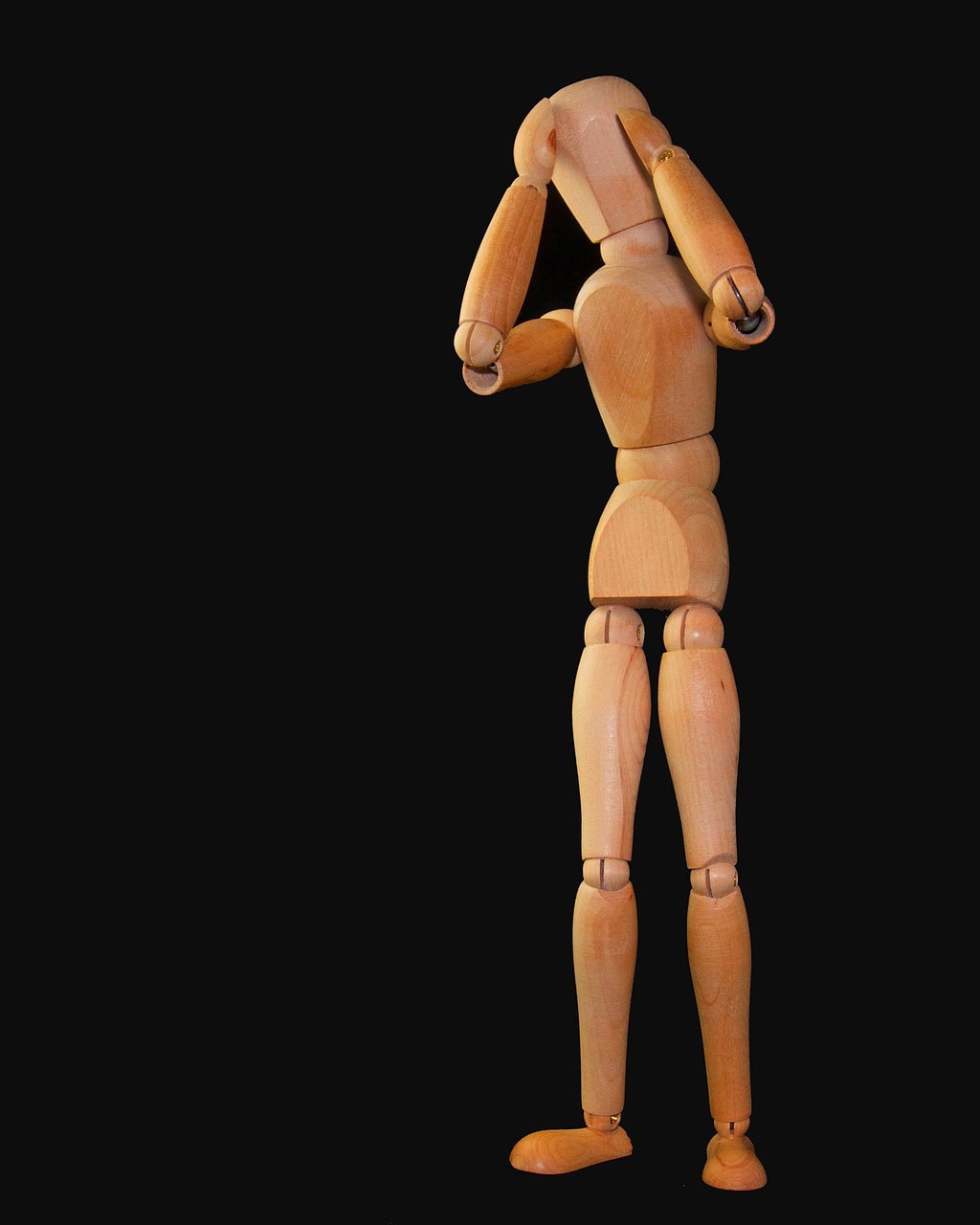 Wooden figure man holding head ozempic headache