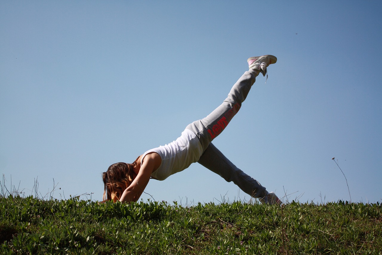 woman outside doing pilates on grass - Is Pilates Good for Weight Loss