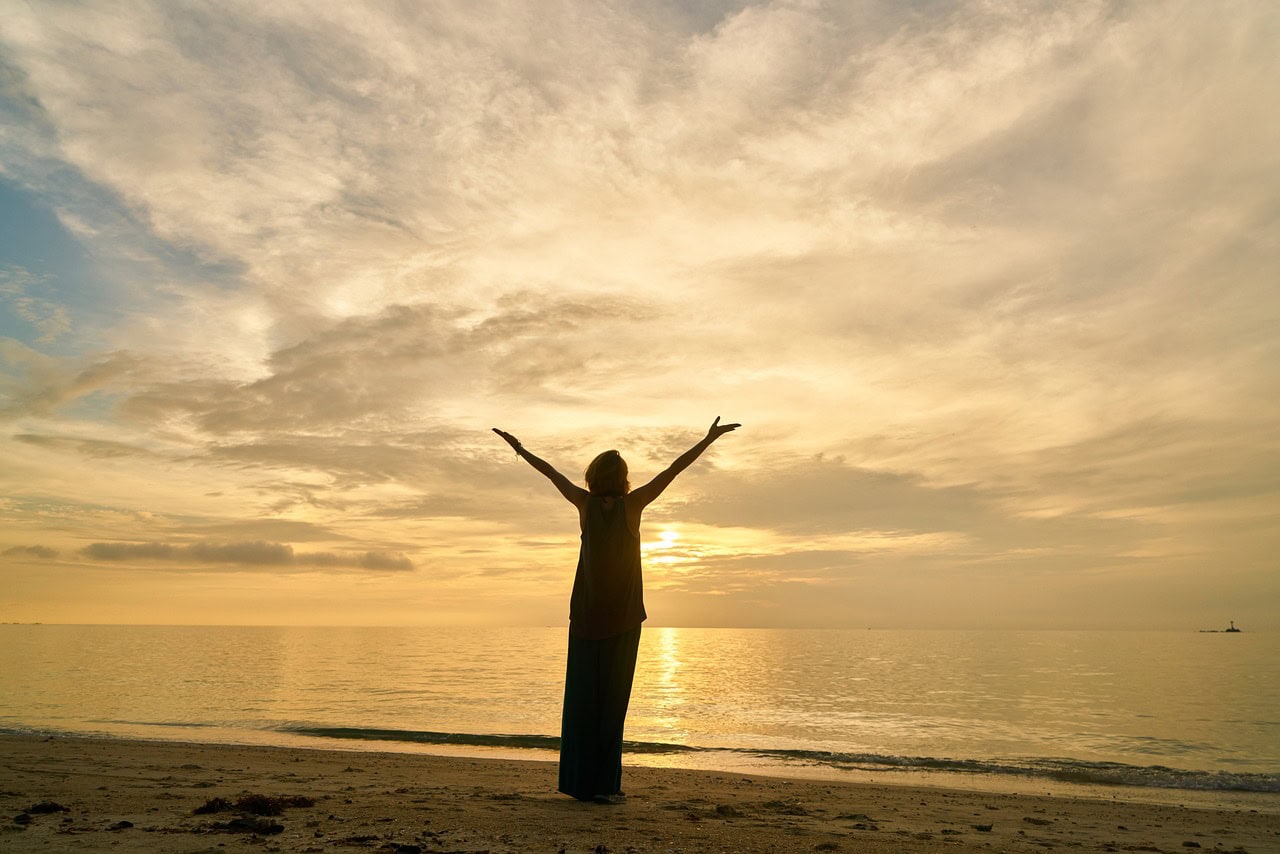 woman stood with sunset behind